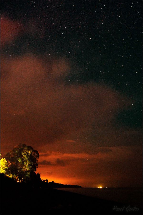 The glow of light pollution from Ochamchira city and the starry sky above it. - Astrophotography